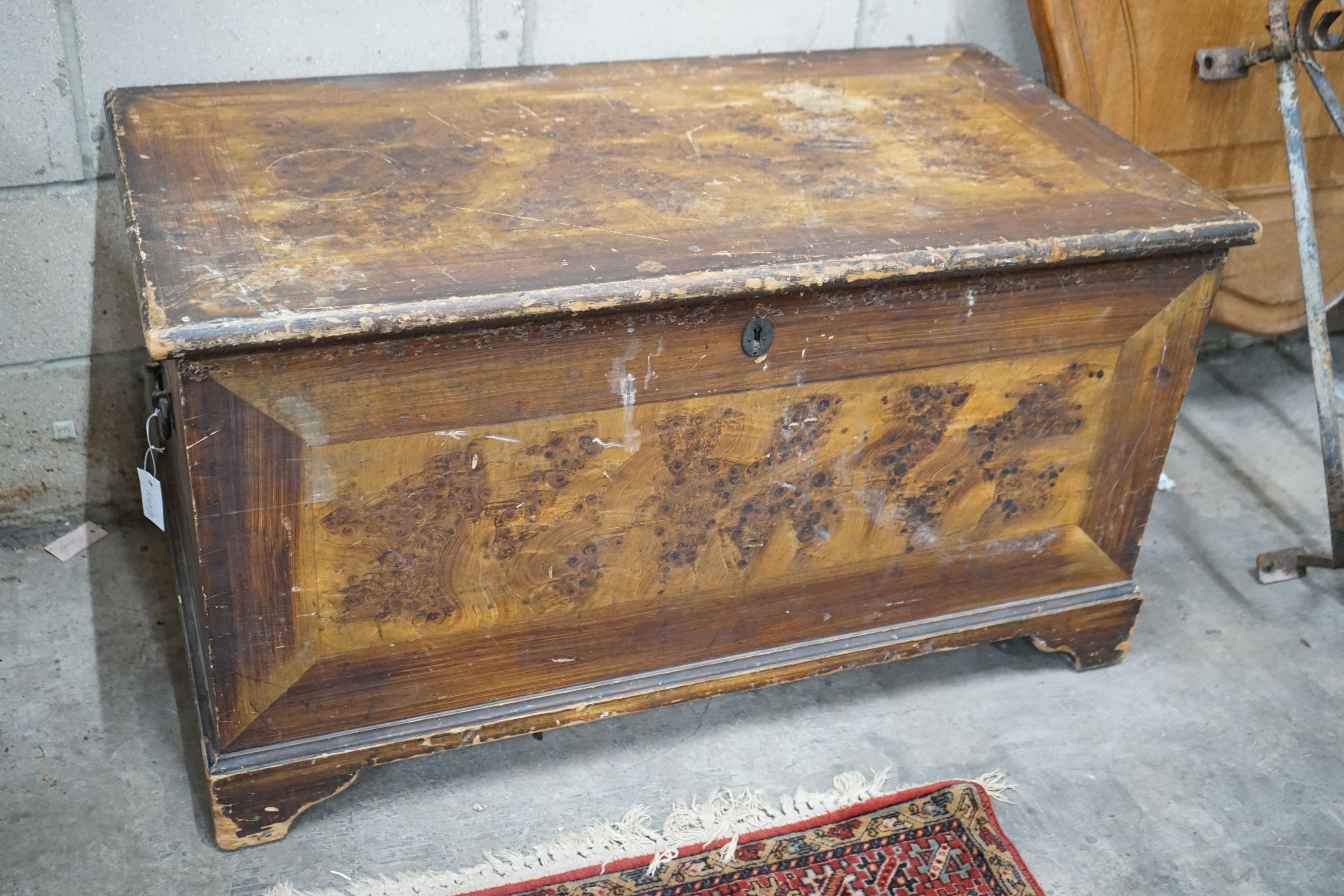 A Victorian pine trunk with simulated painted grain, width 108cm, depth 58cm, height 60cm